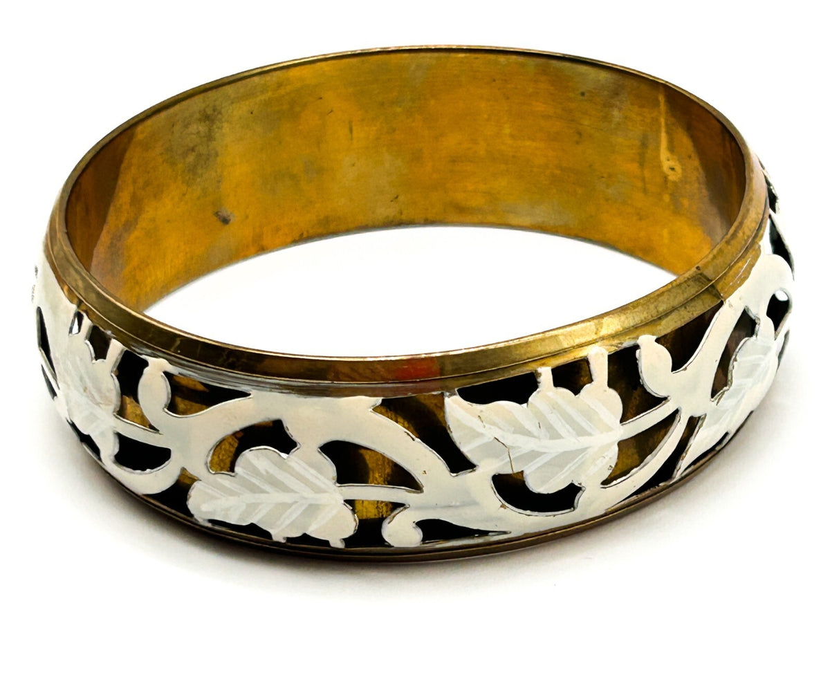 Brass tone bangle with white floral openwork metal design