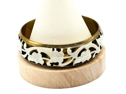 Brass tone bangle with white floral openwork metal design