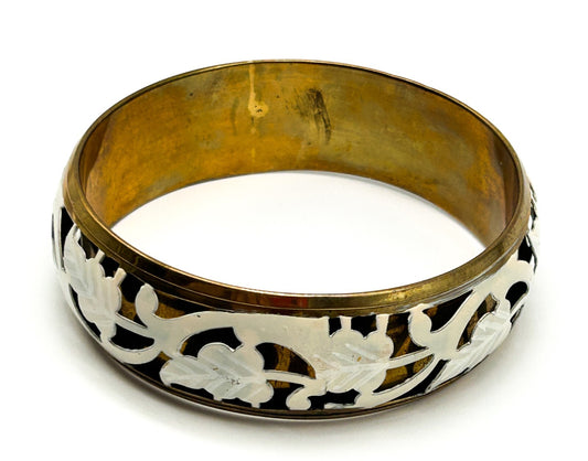 Brass tone bangle with white floral openwork metal design